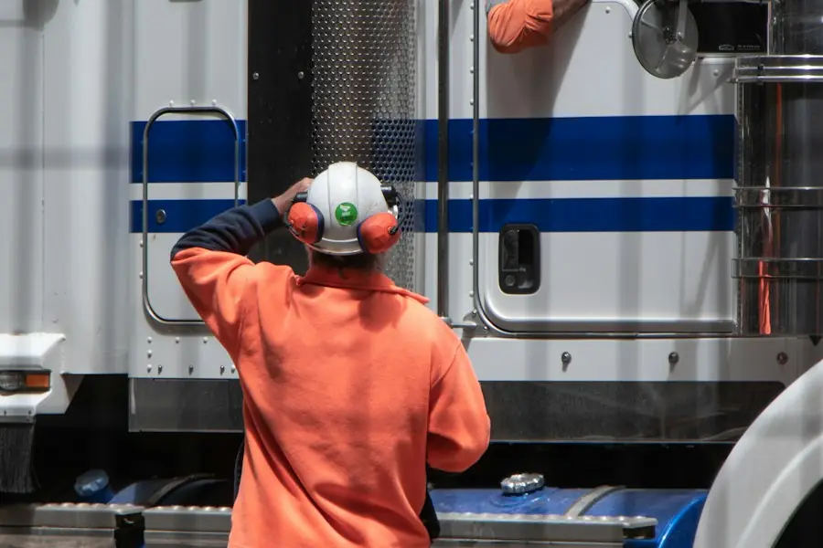 Driver in hi-vis checking a lorry